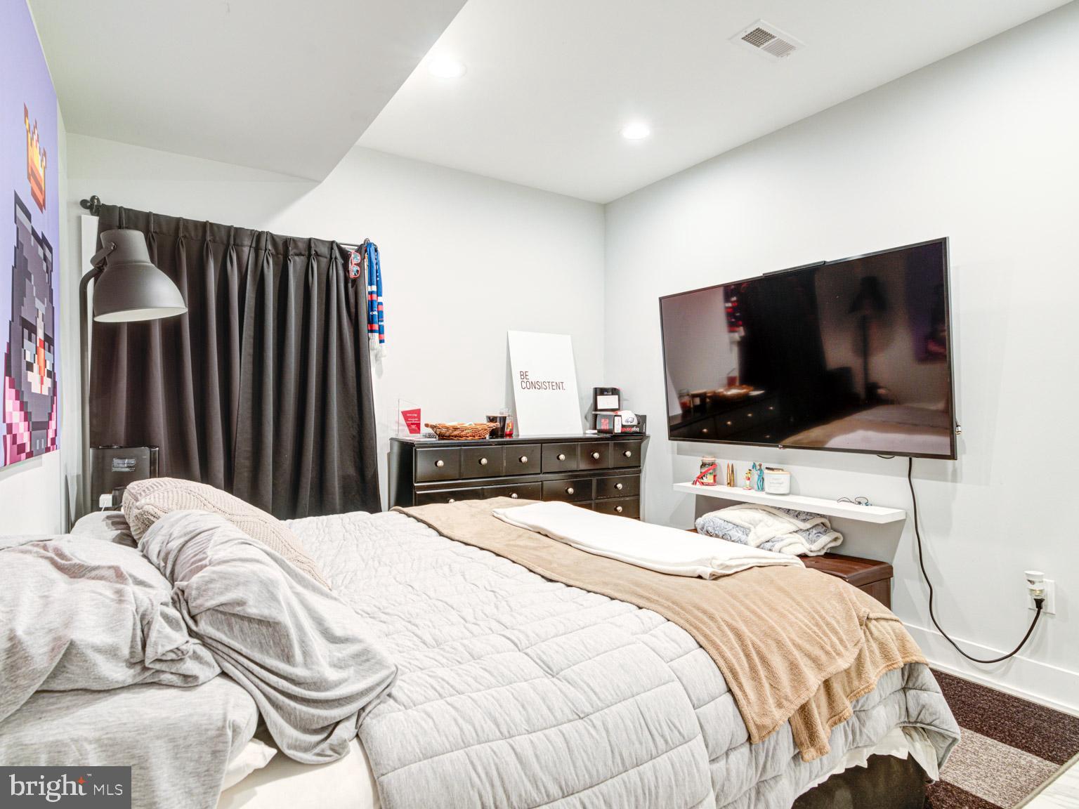 2639 Jasper Street Philadelphia, PA 19125 - Photo 10 of 23 a bedroom with a bed and a flat screen tv