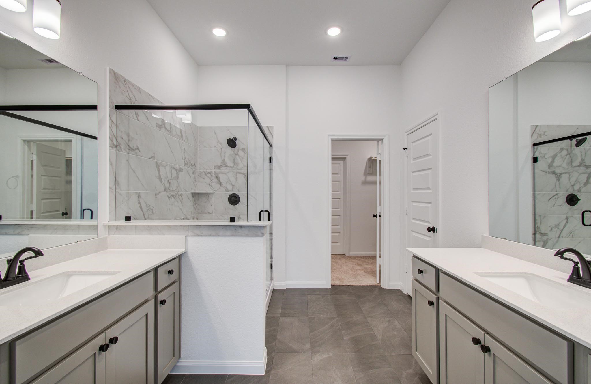 7231 Yarrow Blossom Court Katy, TX 77493 - Photo 27 of 49 a spacious bathroom with a shower sink vanity granite and mirror