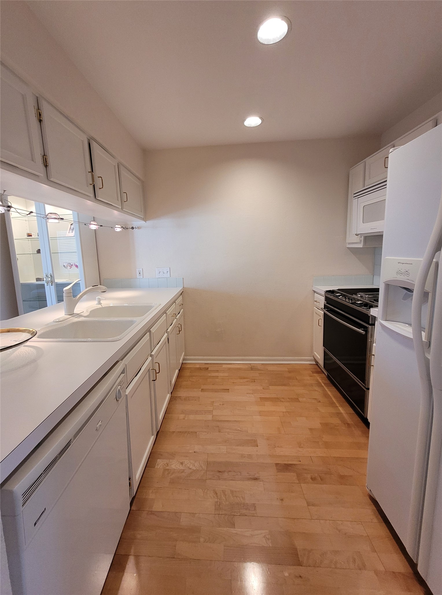 2410 Enfield Road, Unit 7 Austin, TX 78703 - Photo 5 of 19 a kitchen with granite countertop a sink and refrigerator
