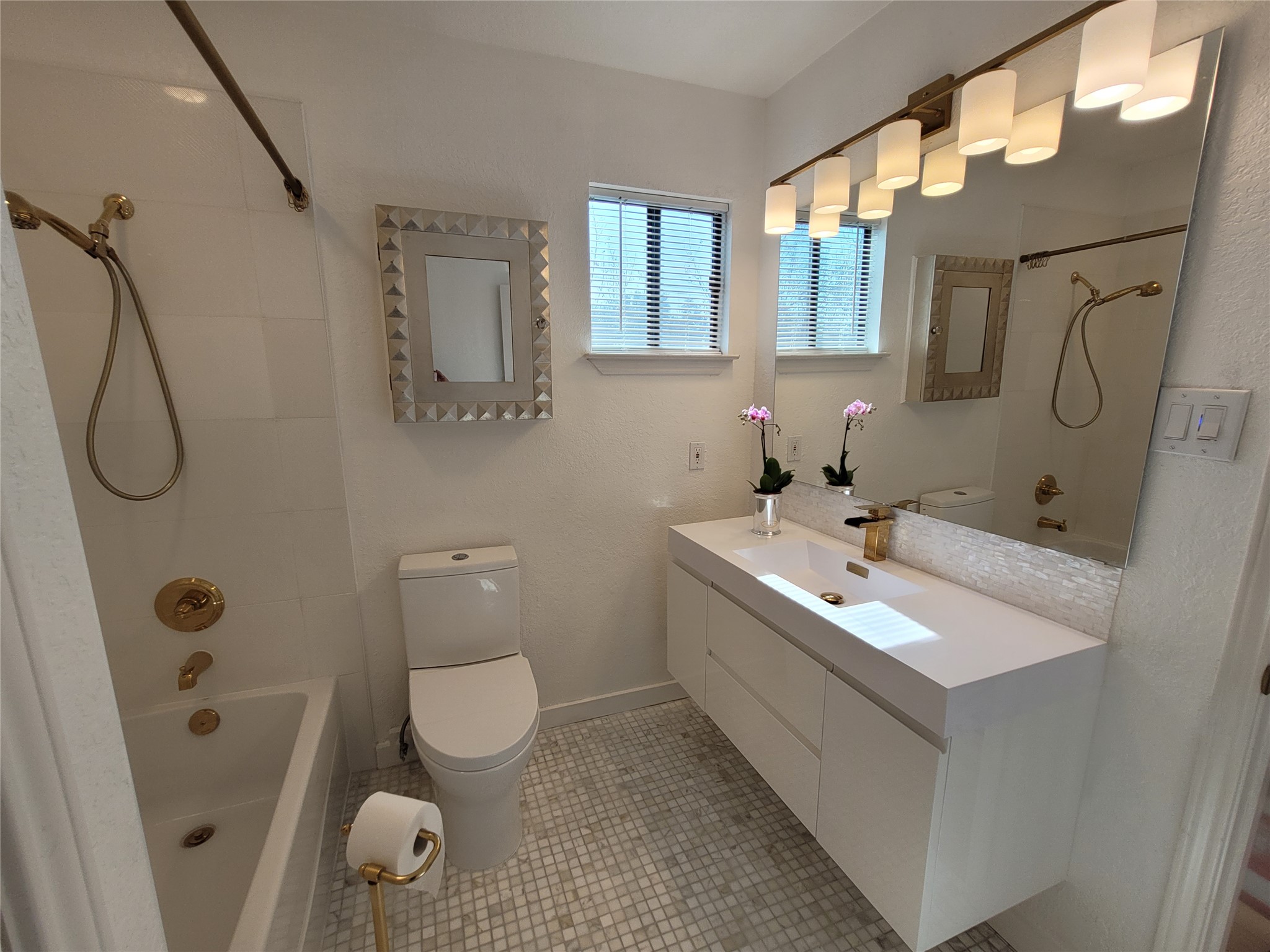 2410 Enfield Road, Unit 7 Austin, TX 78703 - Photo 7 of 19 a bathroom with a sink a toilet and mirror