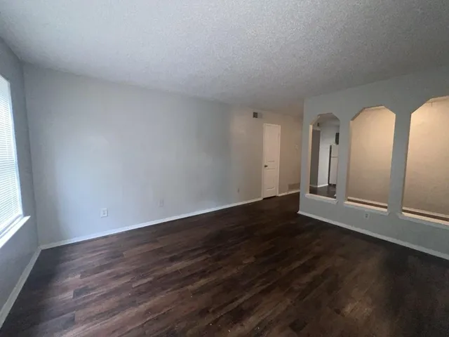 a view of wooden floor and windows in a room