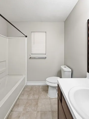 a bathroom with a toilet and a bathtub