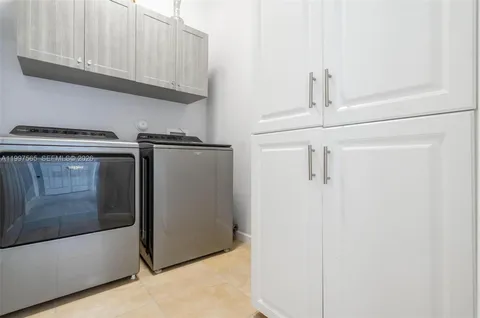 a view of a storage and utility room with washer and dryer