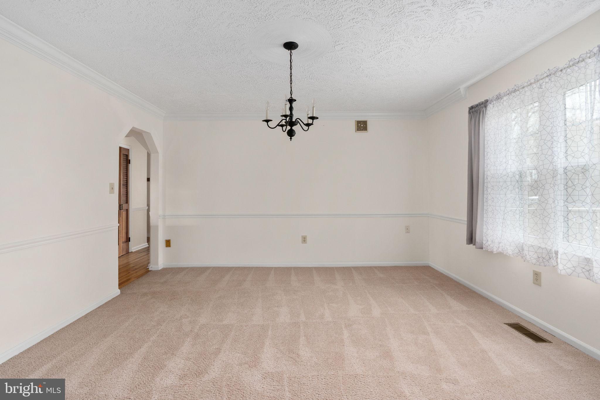 13220 Sillamon Road Goldvein, VA 22720 - Photo 23 of 57 a view of a room with rack on the wall and a window