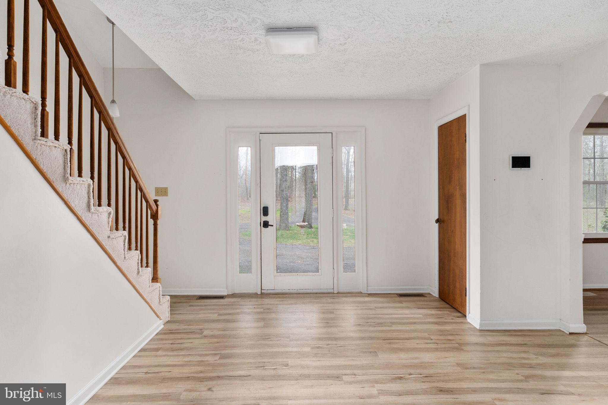 13220 Sillamon Road Goldvein, VA 22720 - Photo 4 of 57 a view of an entryway with wooden floor and door