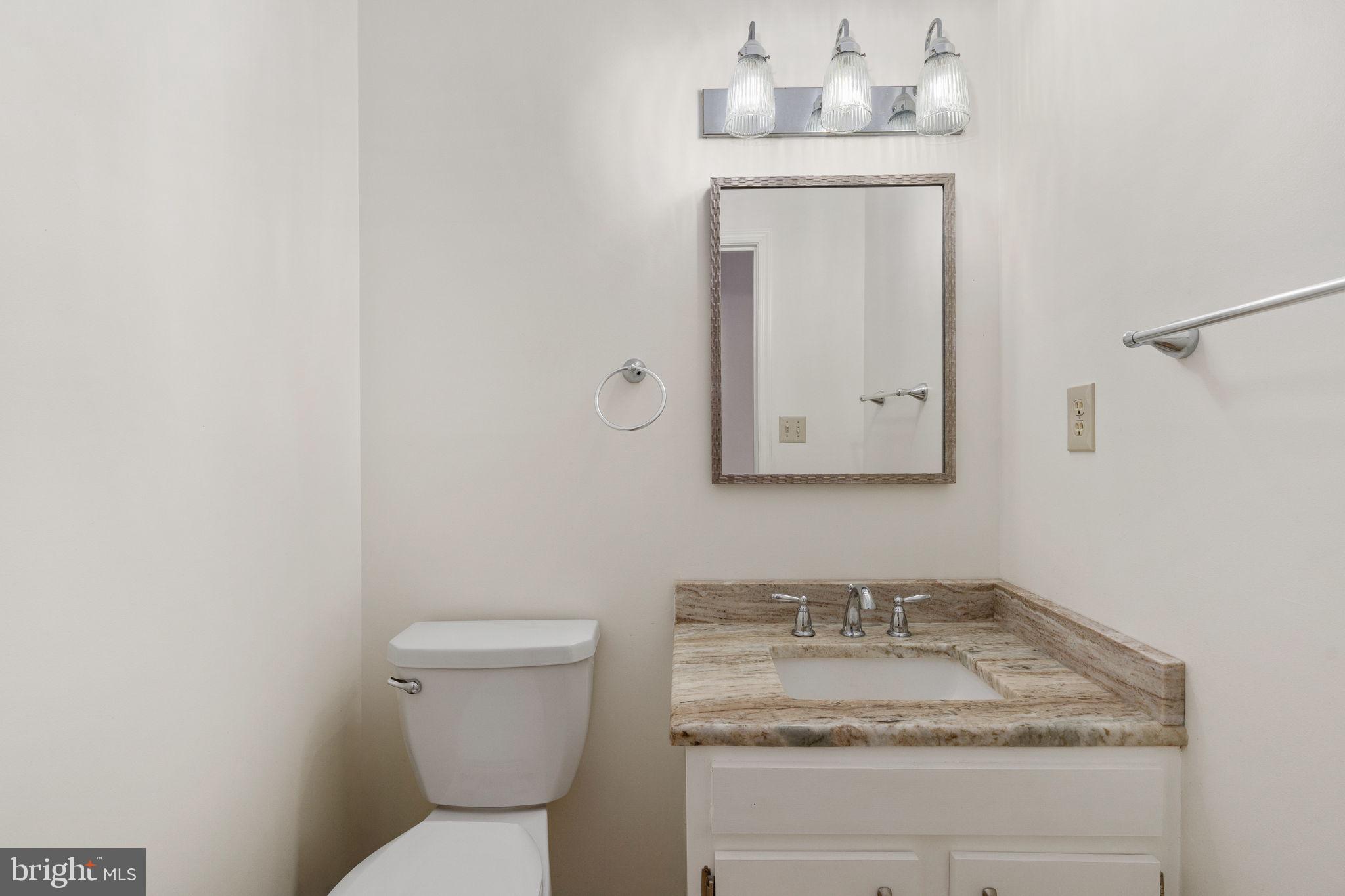 13220 Sillamon Road Goldvein, VA 22720 - Photo 43 of 57 a bathroom with a granite countertop sink and a toilet