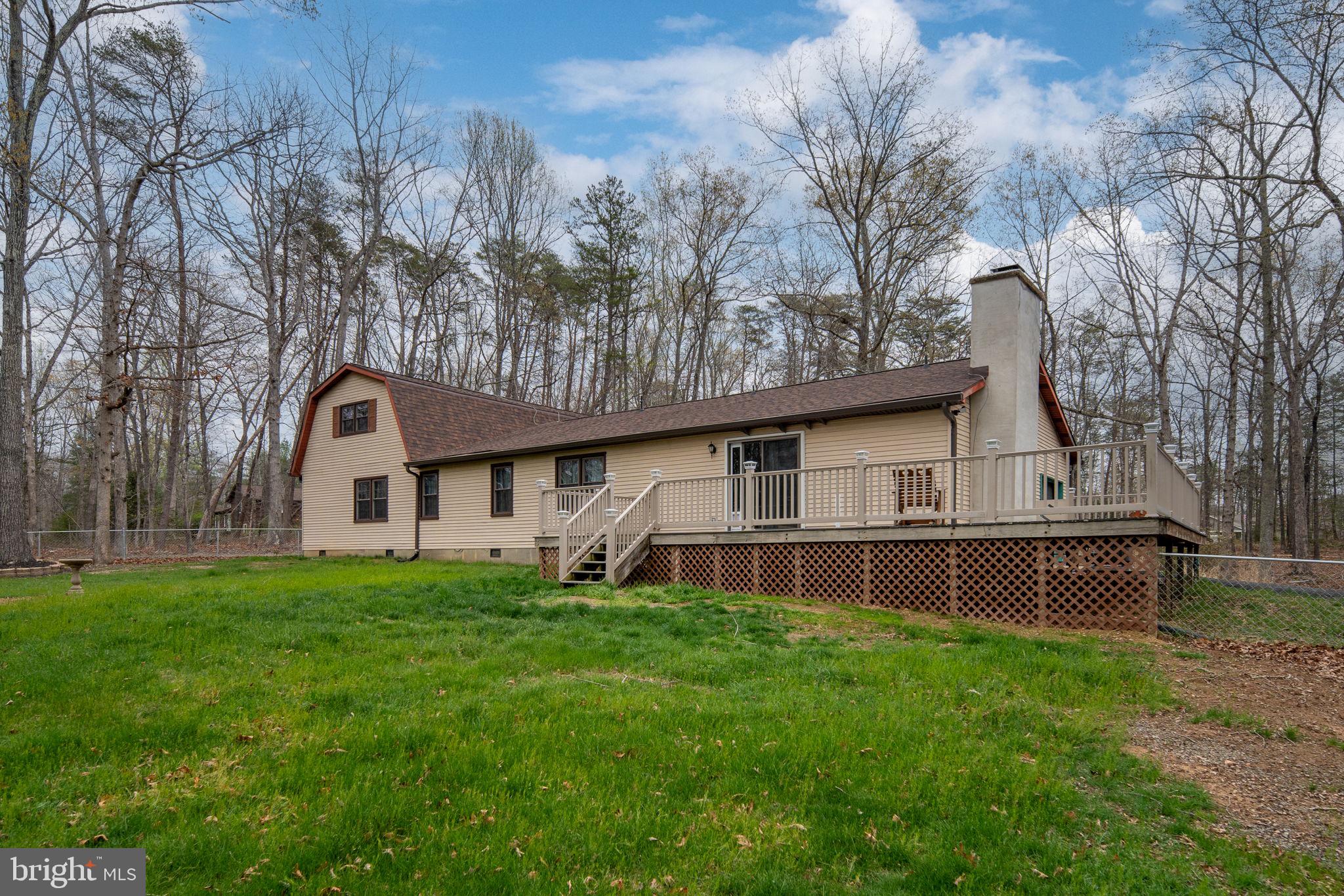 13220 Sillamon Road Goldvein, VA 22720 - Photo 46 of 57 a front view of house with yard and trees