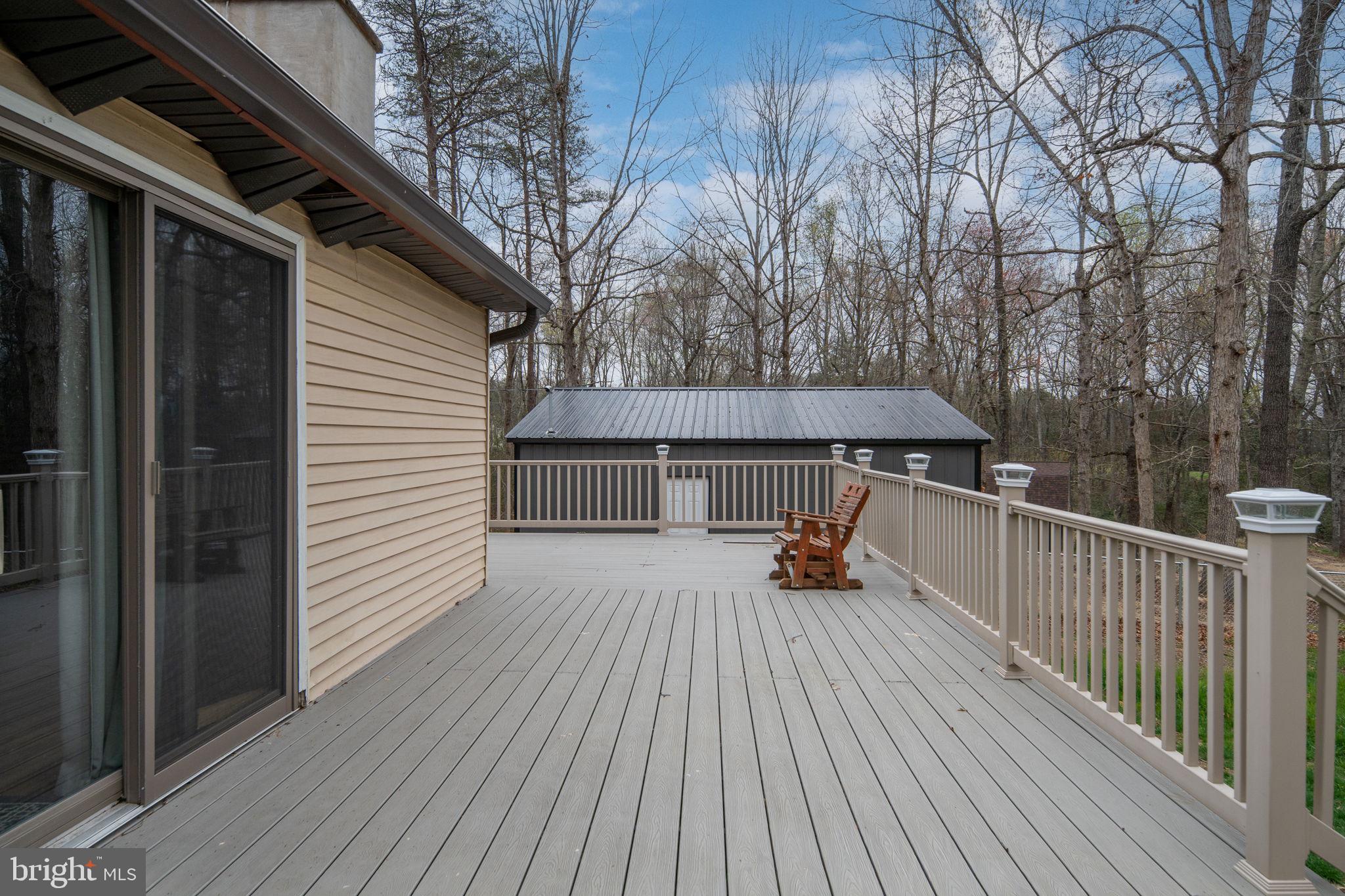 13220 Sillamon Road Goldvein, VA 22720 - Photo 48 of 57 a view of backyard with a deck and wooden floor