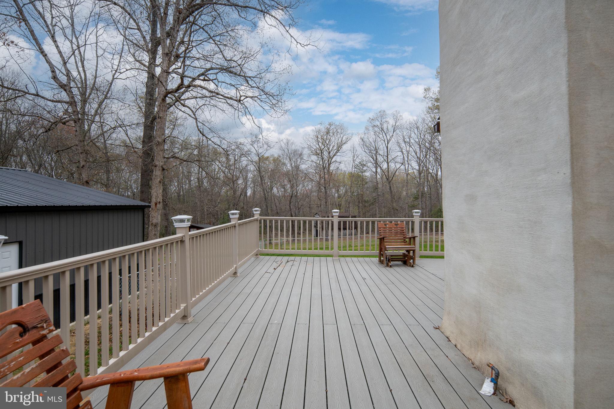13220 Sillamon Road Goldvein, VA 22720 - Photo 50 of 57 a view of deck with wooden floor and trees