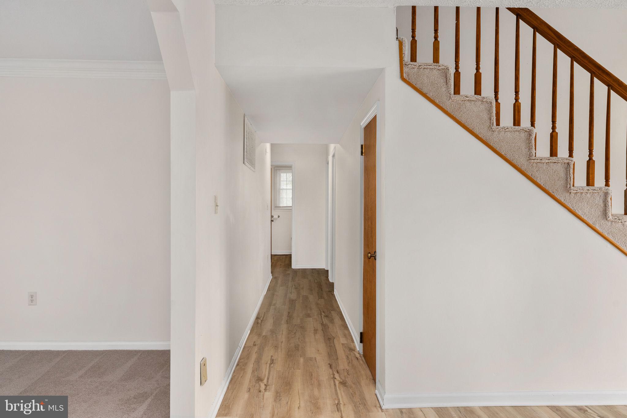 13220 Sillamon Road Goldvein, VA 22720 - Photo 9 of 57 a view of a hallway with wooden floor and staircase