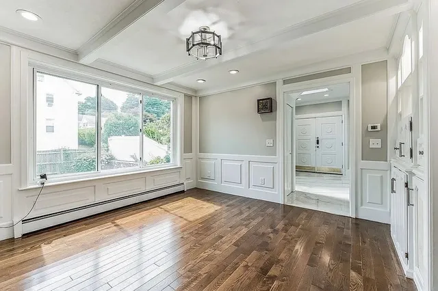 wooden floor in an empty room with a window
