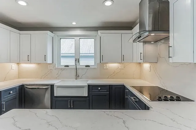 a kitchen with stainless steel appliances granite countertop a sink a stove and cabinets