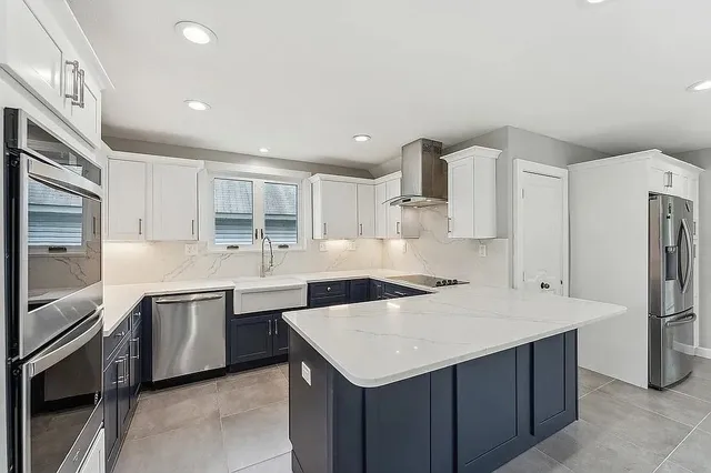 a kitchen with stainless steel appliances a sink and a refrigerator