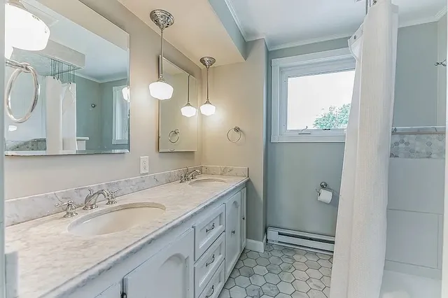 a white house that has tree in front of it