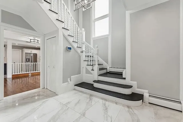 a view of entryway and hall with wooden floor