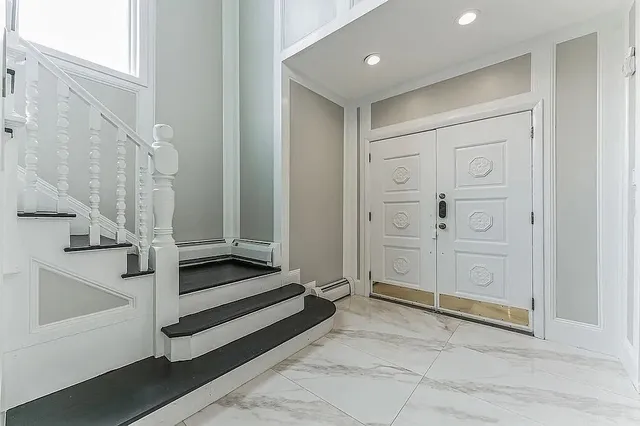 a view of a hallway with closet and entryway