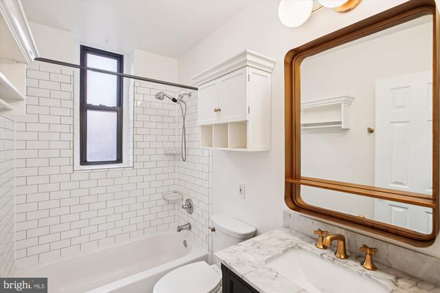 a bathroom with a bathtub and a sink