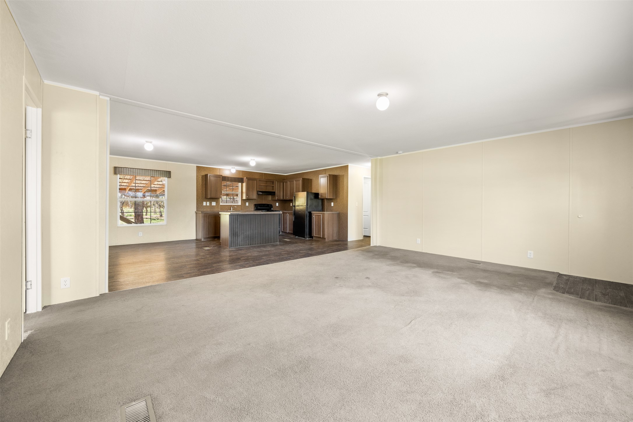 103 Spring View Drive Johnson City, TX 78636 - Photo 8 of 31 Unfurnished living room featuring dark carpet