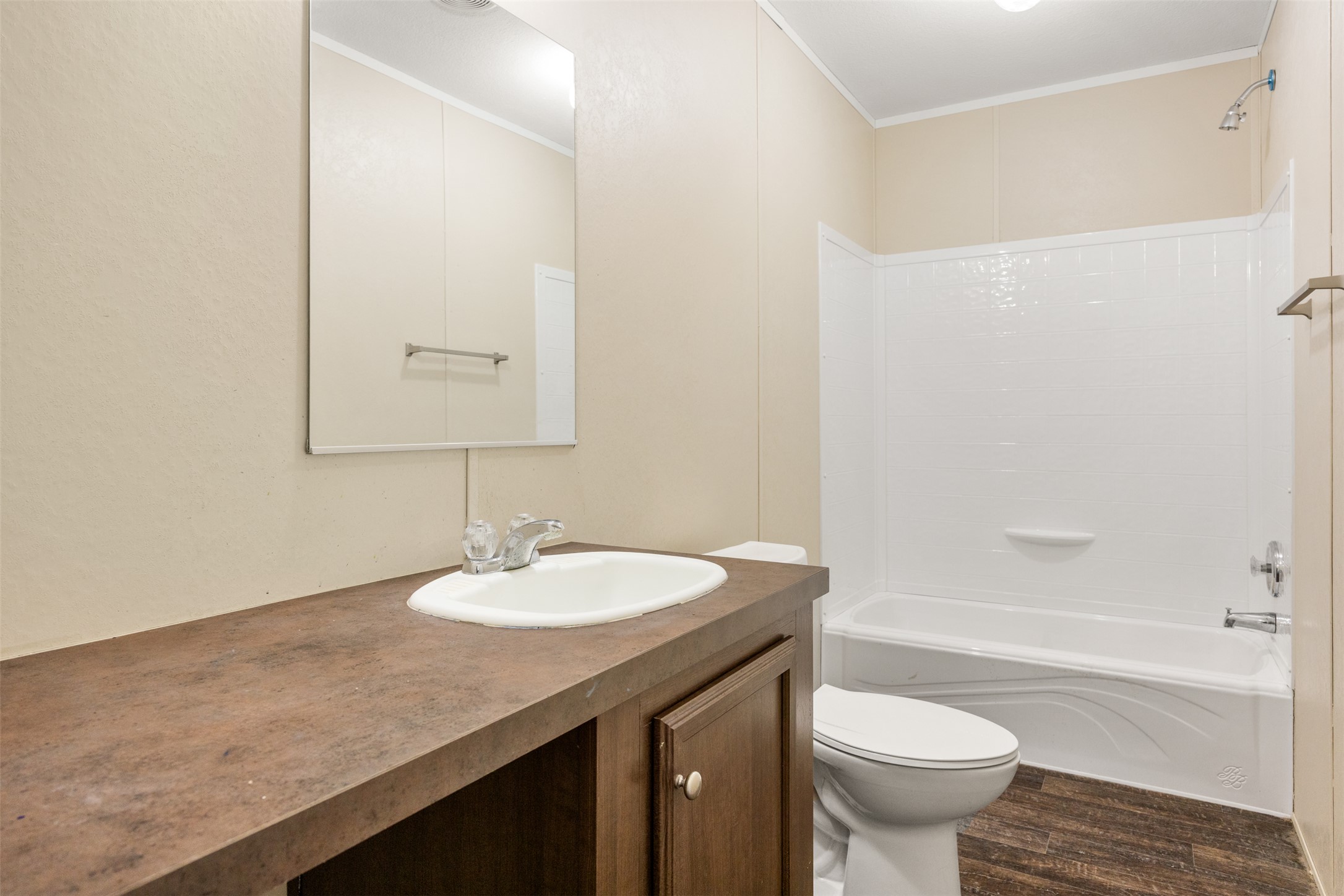 103 Spring View Drive Johnson City, TX 78636 - Photo 15 of 31 Bathroom with vanity, ornamental molding, dark wood-style floors, and shower / bath combination