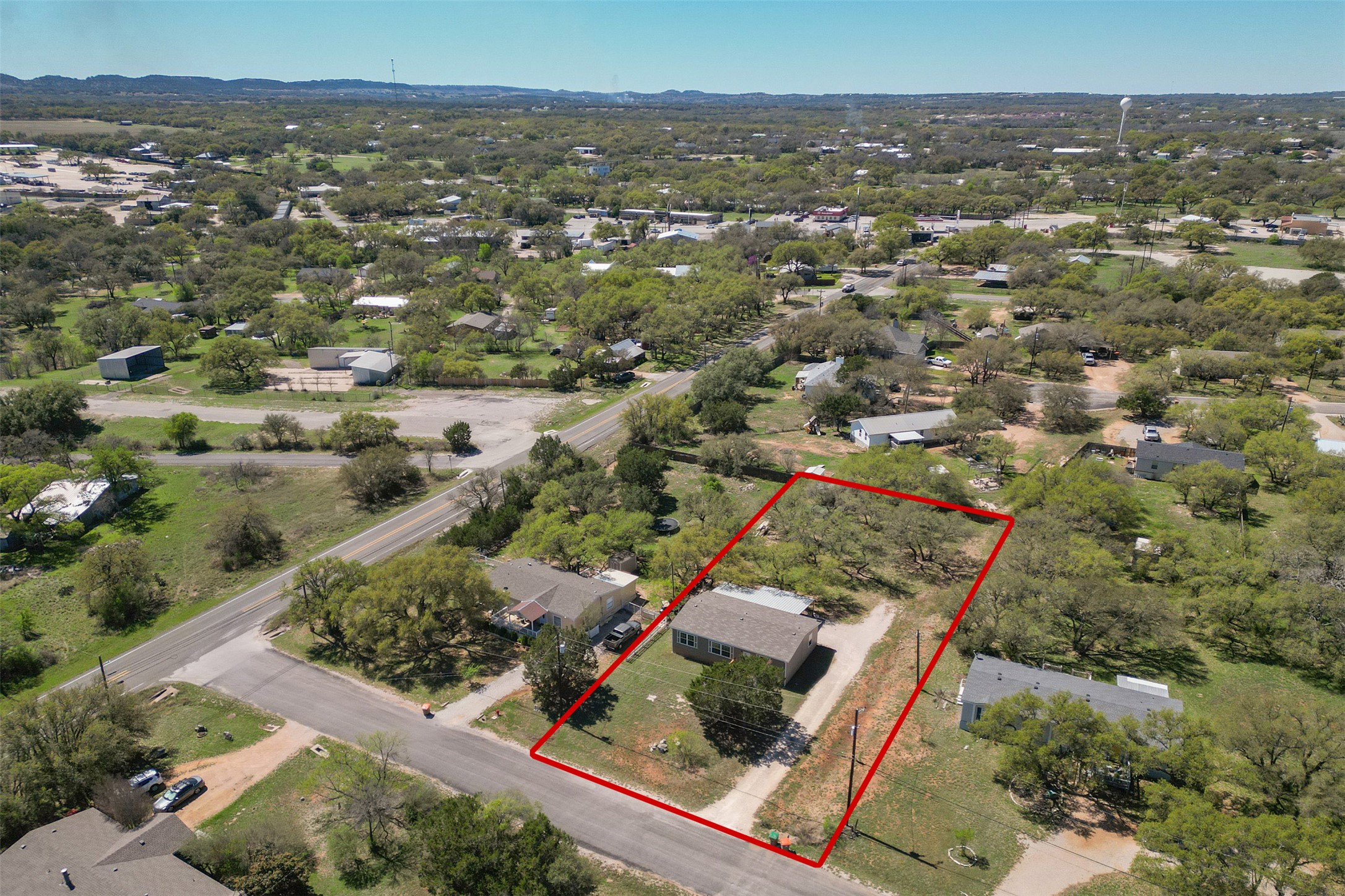 103 Spring View Drive Johnson City, TX 78636 - Photo 3 of 31 Aerial perspective of suburban area with property boundaries highlighted