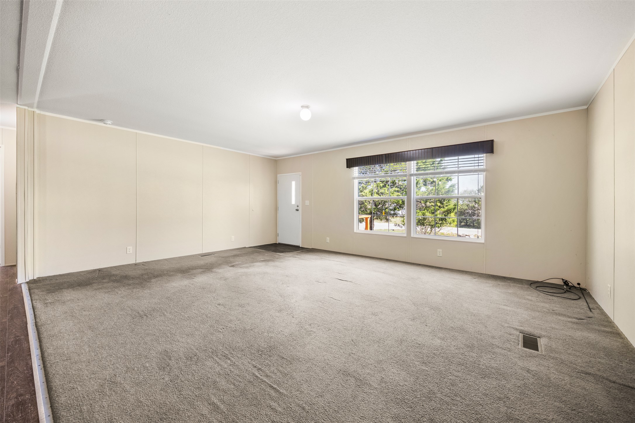 103 Spring View Drive Johnson City, TX 78636 - Photo 5 of 31 Carpeted empty room featuring crown molding