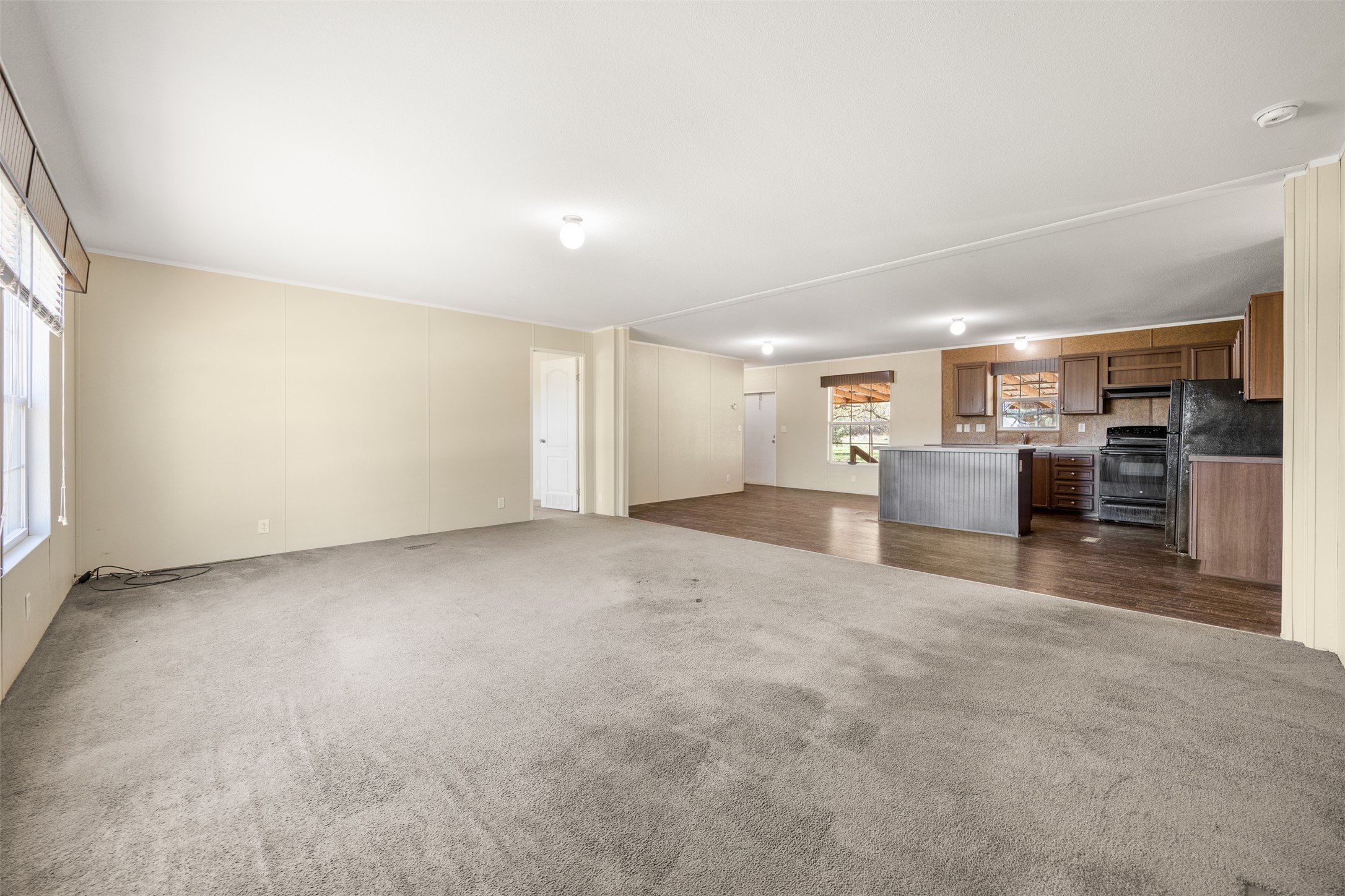 103 Spring View Drive Johnson City, TX 78636 - Photo 7 of 31 Unfurnished living room featuring dark carpet