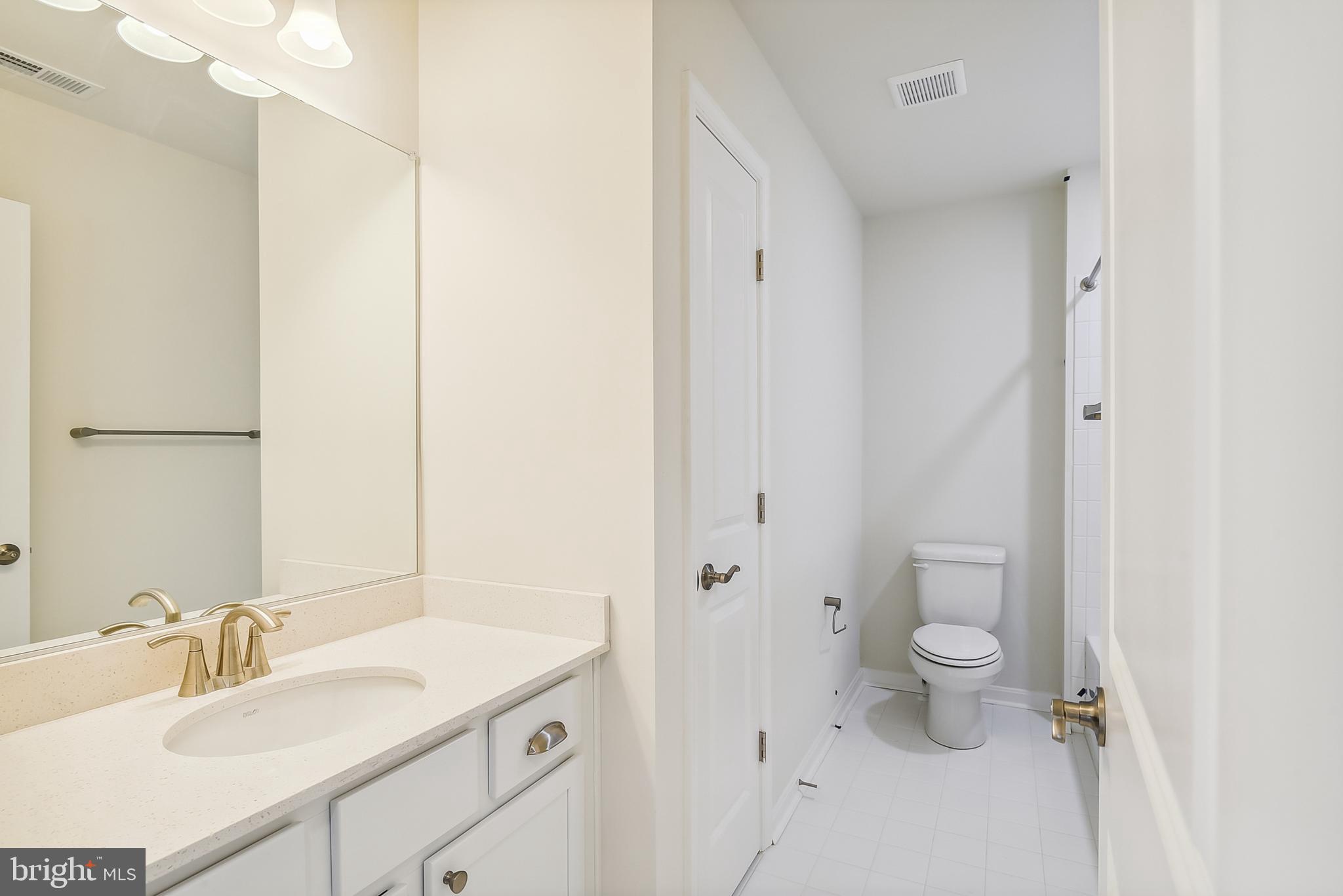15330 Hildegard Lane Silver Spring, MD 20905 - Photo 19 of 45 a bathroom with a granite countertop sink toilet and shower