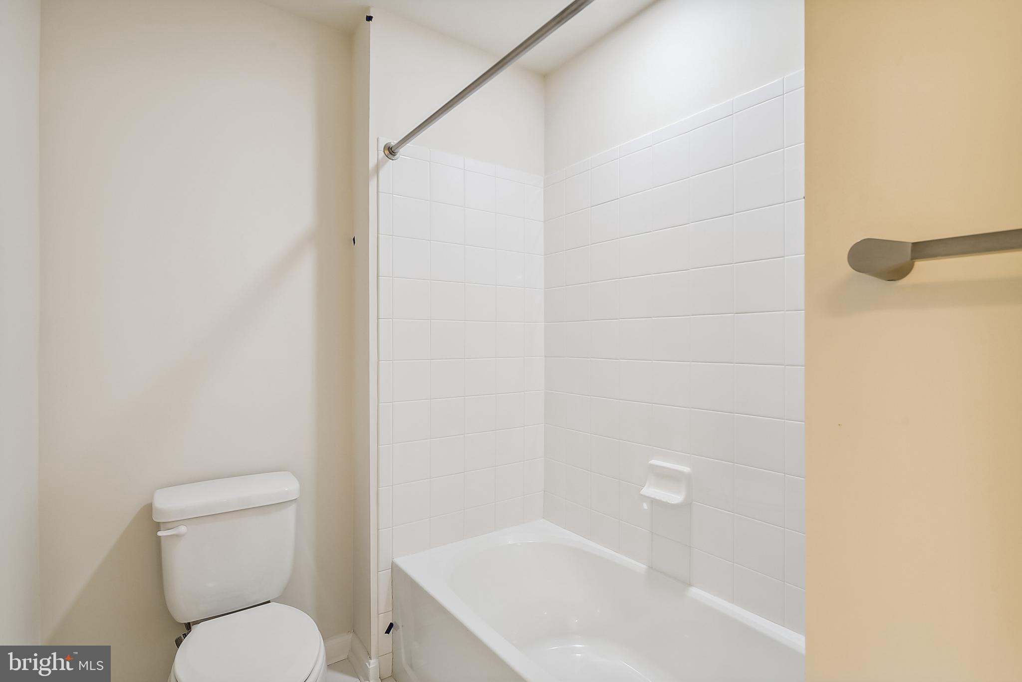15330 Hildegard Lane Silver Spring, MD 20905 - Photo 20 of 45 a white toilet sitting next to a bathroom sink