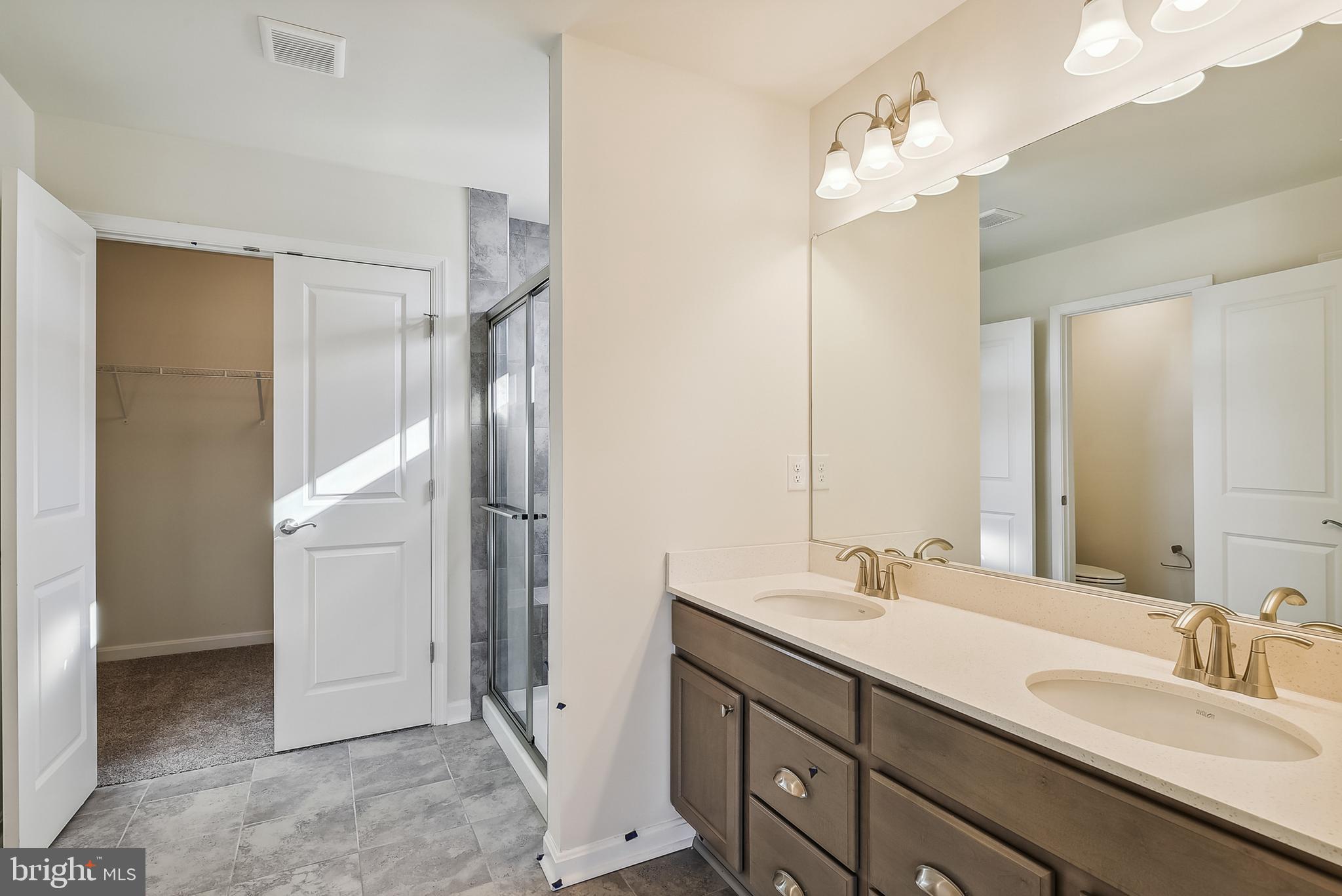 15330 Hildegard Lane Silver Spring, MD 20905 - Photo 28 of 45 a bathroom with a double vanity sink mirror and shower
