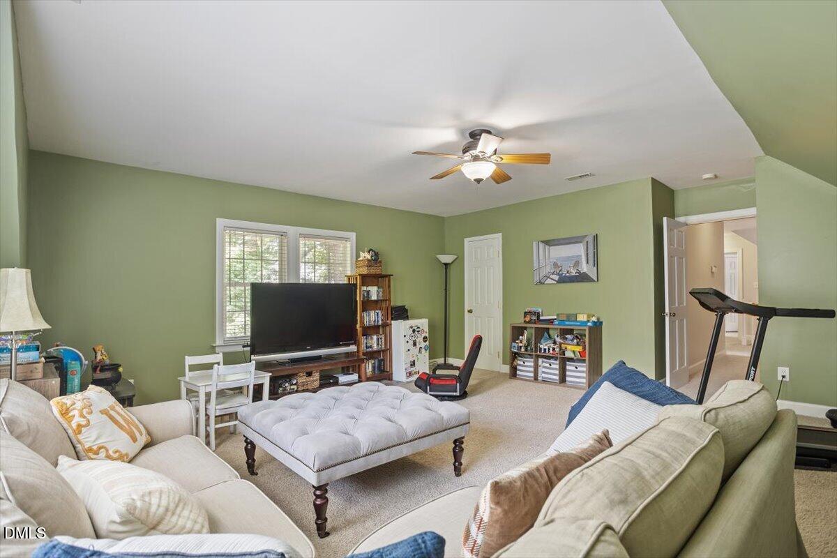 1808 Thorpshire Drive Raleigh, NC 27615 - Photo 15 of 17 a living room with furniture and a flat screen tv