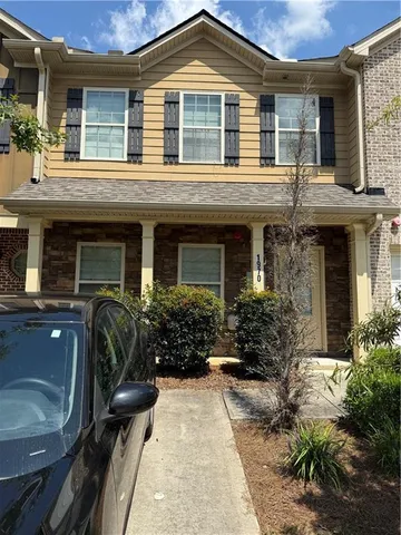 a view of a house with a chairs in patio