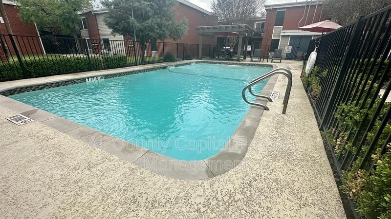 5426 Menchaca Road, Unit 214 Austin, TX 78745 - Photo 4 of 8 a view of a swimming pool with a patio