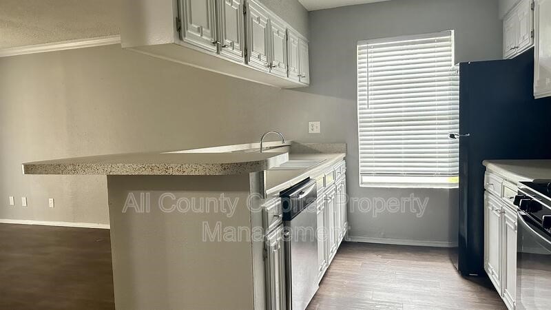 5426 Menchaca Road, Unit 214 Austin, TX 78745 - Photo 7 of 8 a view of a kitchen from the hallway