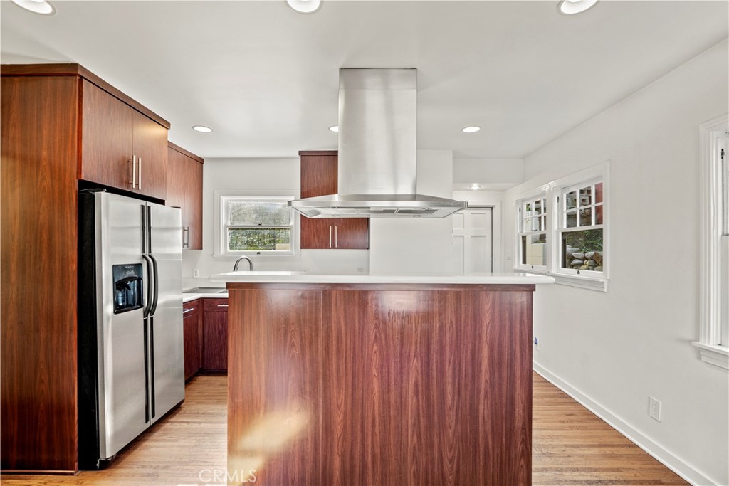 2559 Corralitas Drive Silver Lake, CA 90039 - Photo 19 of 54 a kitchen with stainless steel appliances kitchen island granite countertop a refrigerator a sink and wooden cabinets