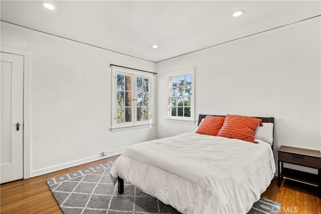 2559 Corralitas Drive Silver Lake, CA 90039 - Photo 27 of 54 a bedroom with a bed and wooden floor
