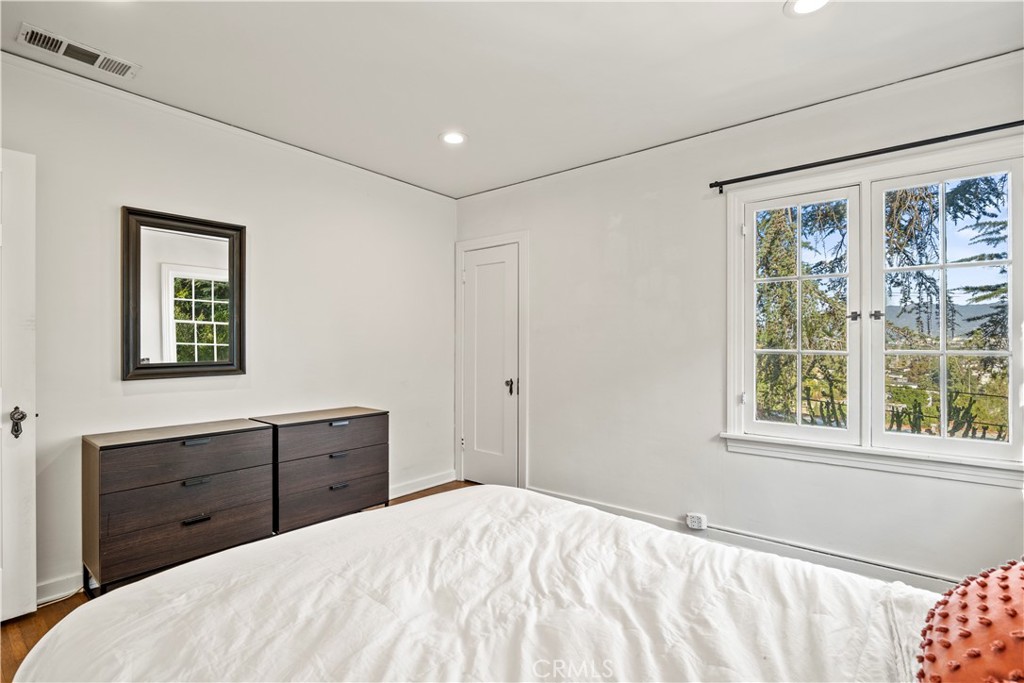 2559 Corralitas Drive Silver Lake, CA 90039 - Photo 28 of 54 a bedroom with a bed and a window