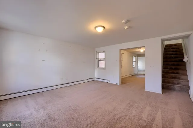 an empty room with windows and closet