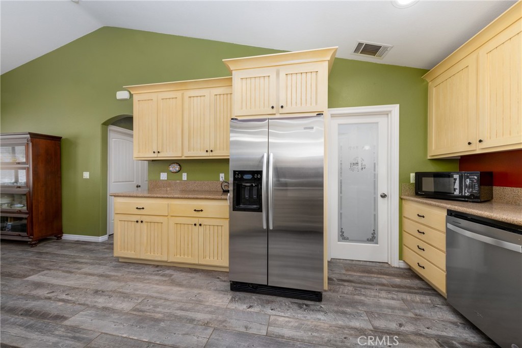 5935 Monte Vista Road Phelan, CA 92371 - Photo 14 of 58 a kitchen with granite countertop a refrigerator oven a sink and cabinets