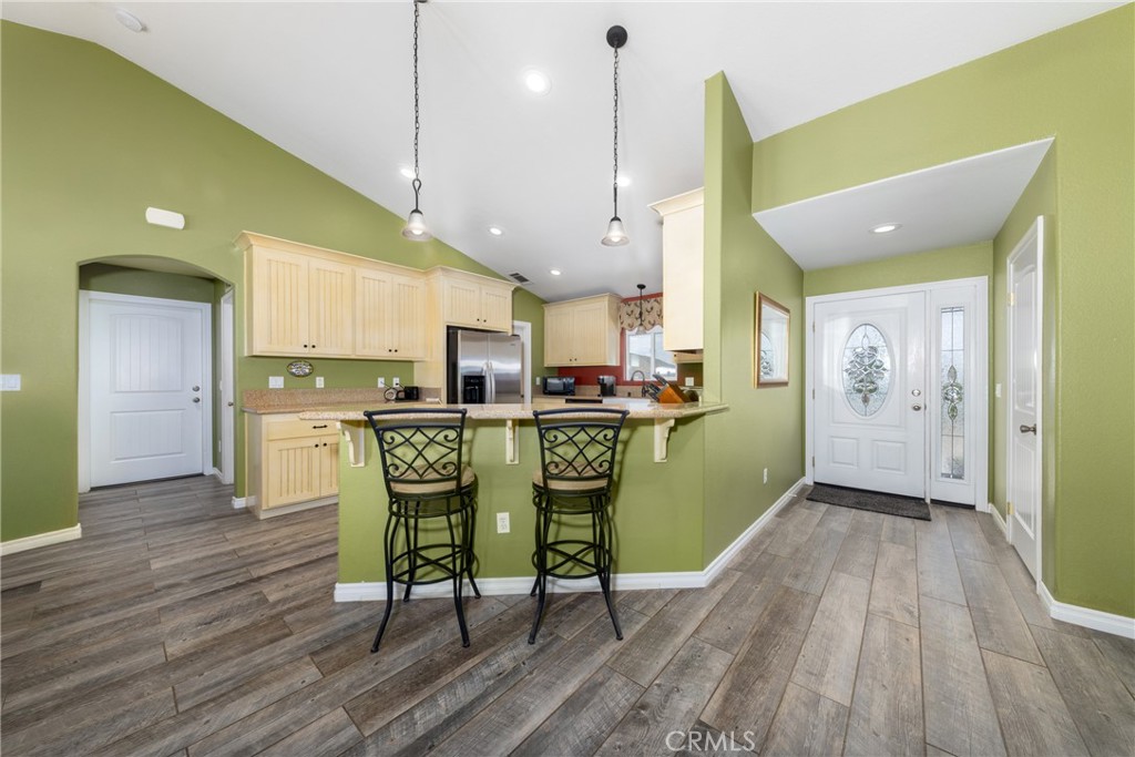 5935 Monte Vista Road Phelan, CA 92371 - Photo 19 of 58 a dining room with stainless steel appliances kitchen island wooden floors and view kitchen