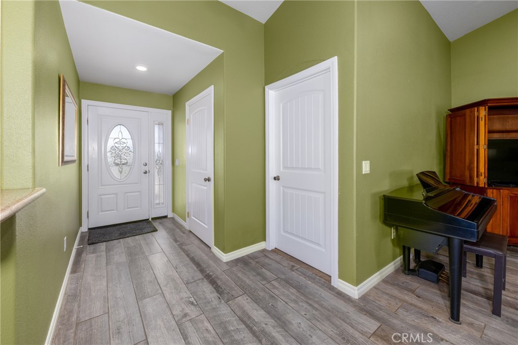 5935 Monte Vista Road Phelan, CA 92371 - Photo 32 of 58 a view of a hallway with wooden floor and a workspace