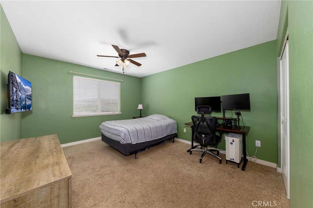 5935 Monte Vista Road Phelan, CA 92371 - Photo 36 of 58 a bedroom with a workspace and a window