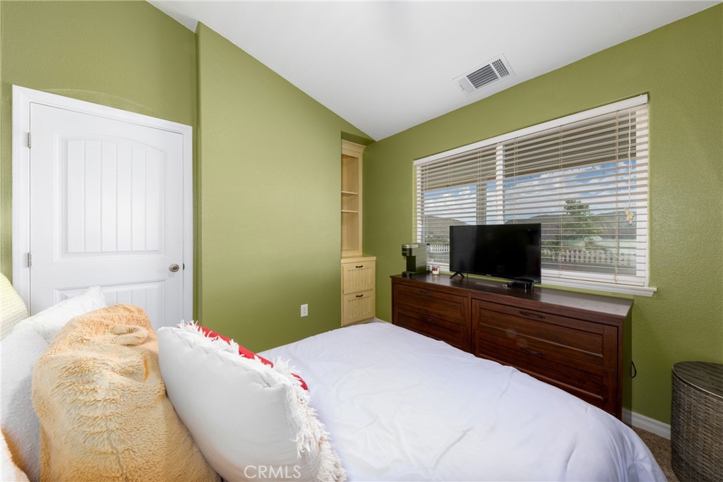5935 Monte Vista Road Phelan, CA 92371 - Photo 37 of 58 a bedroom with a bed and a flat screen tv