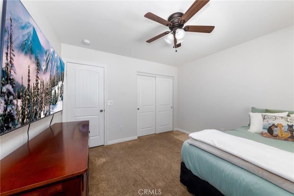 5935 Monte Vista Road Phelan, CA 92371 - Photo 38 of 58 a bedroom with a bed and a painting on the wall