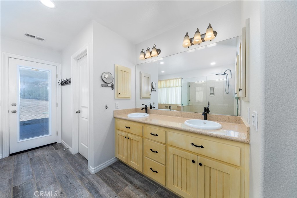 5935 Monte Vista Road Phelan, CA 92371 - Photo 42 of 58 a spacious bathroom with a granite countertop sink mirror and vanity