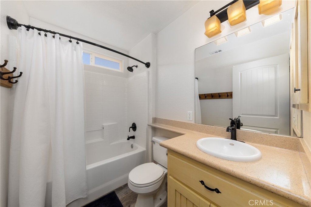 5935 Monte Vista Road Phelan, CA 92371 - Photo 43 of 58 a bathroom with a sink a toilet and shower