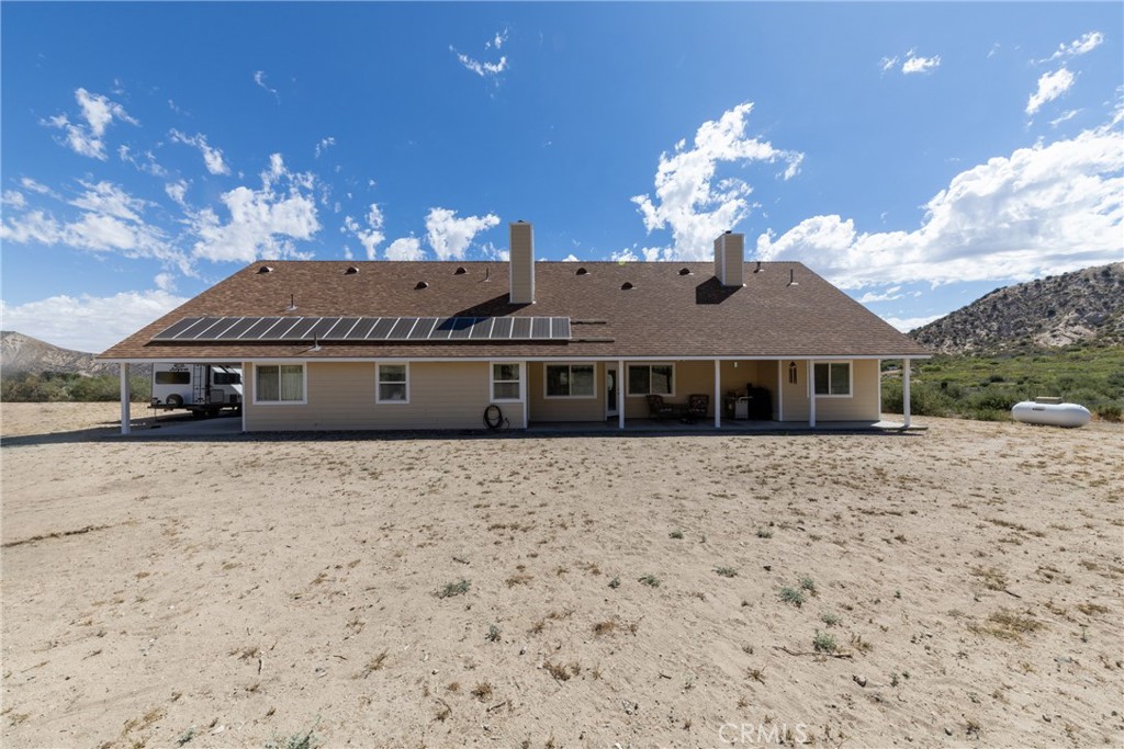 5935 Monte Vista Road Phelan, CA 92371 - Photo 48 of 58 a front view of a house with a yard and garage