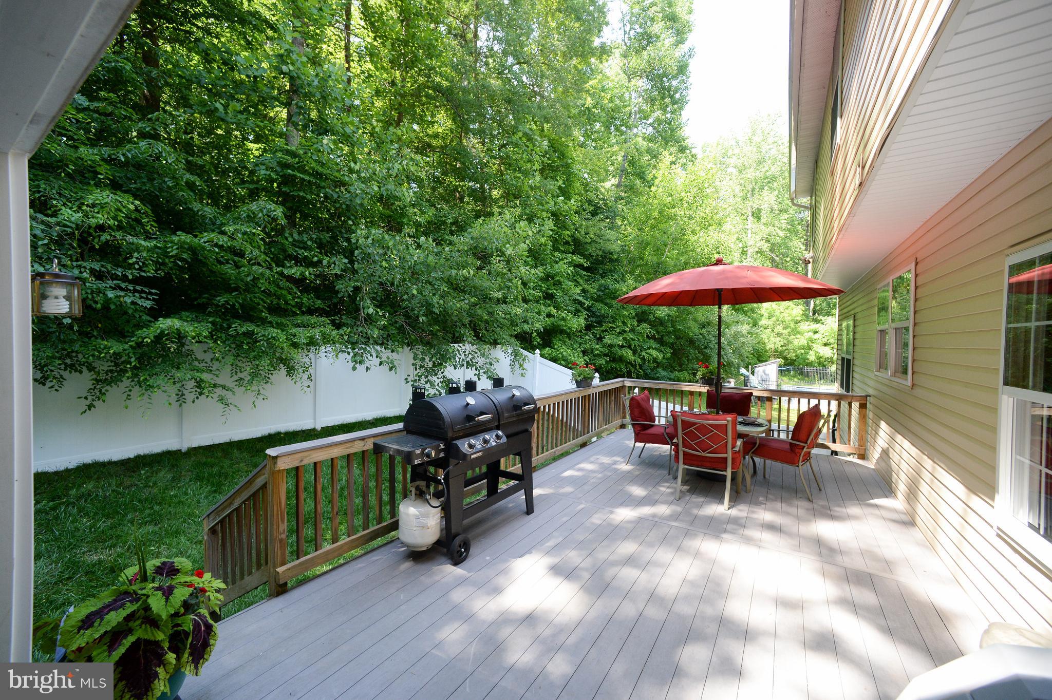 12017 Cross Rd Trail Brandywine, MD 20613 - Photo 22 of 30 Fenced in backyard deck with peaceful wooded view