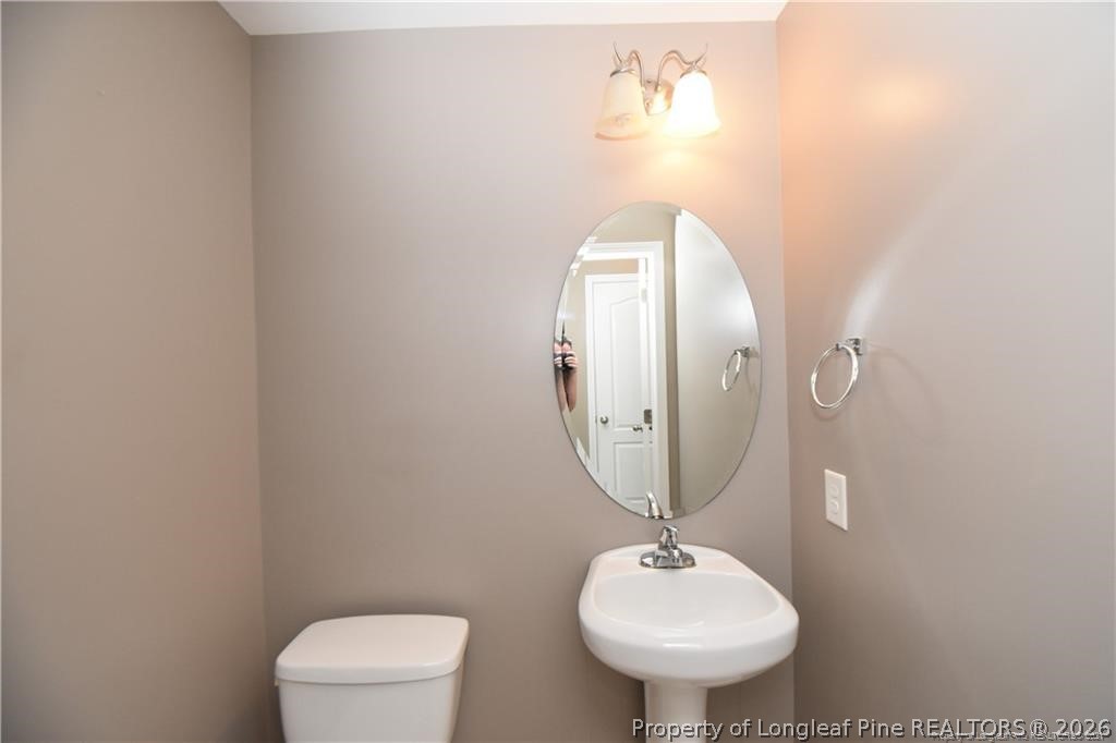 131 South Prince Henry Way Cameron, NC 28326 - Photo 14 of 26 a bathroom with a toilet sink and mirror