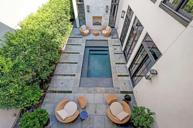 an outdoor living room with furniture and a fireplace