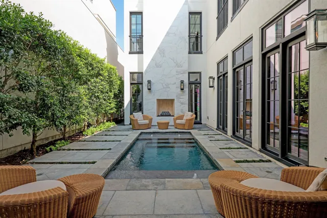 a view of a patio with couches table and chairs and potted plants